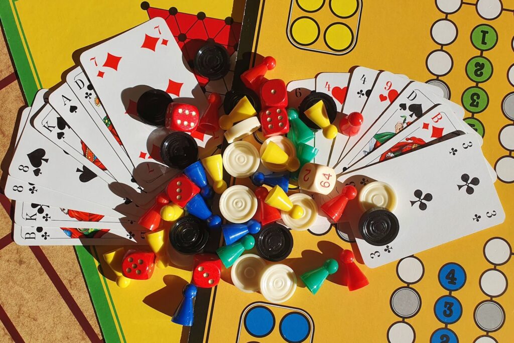 Various board games, game pieces, dices and playing cards