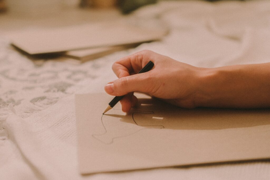 person writing on white paper