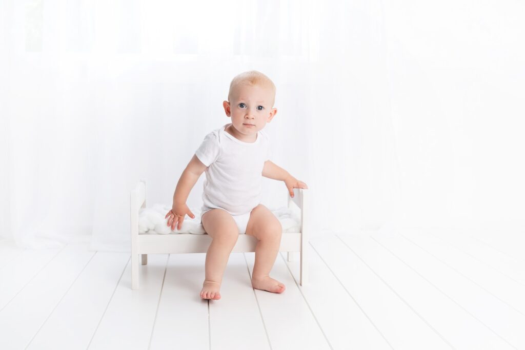 baby minimal white background on bed